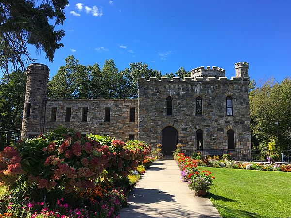 Winnekenni stone castle surrounded by hydrangea bushes