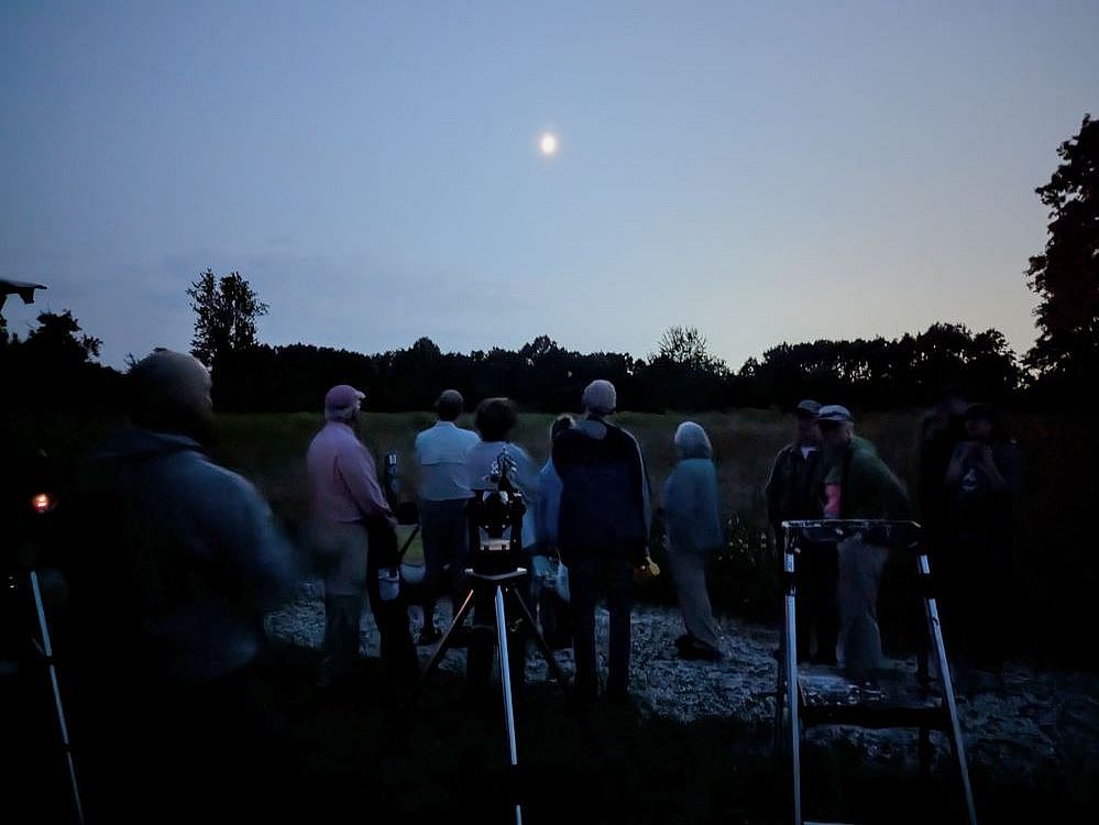 people stargazing with telescopes