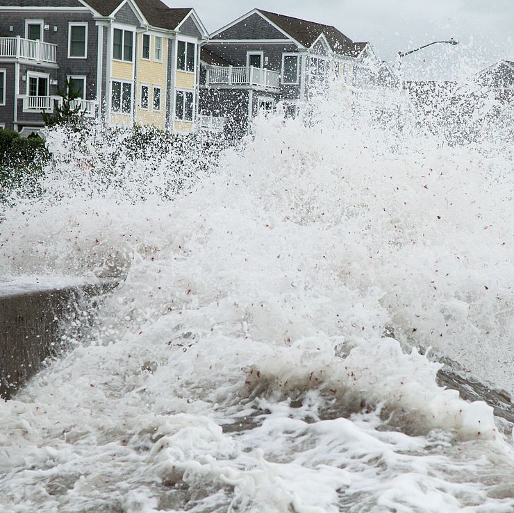 storm surge next to some houses